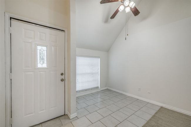 Entryway featuring light tile patterned flooring, a ceiling fan, and vaulted ceiling | Image 7