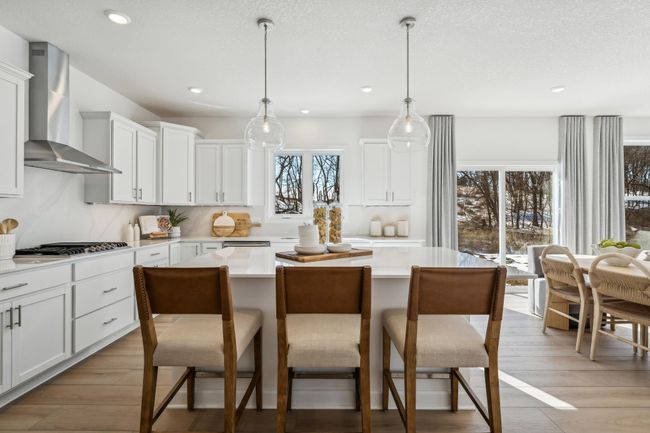 Photo is of the actual model. There is plenty of room for seating at the kitchen island and the dining area adjacent! | Image 4