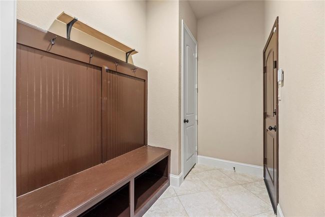 This very convenient mud room is located between the house and the attached garage and even provides closet space. | Image 23