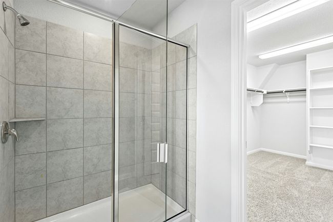 Bathroom with a spacious closet and a stall shower | Image 28