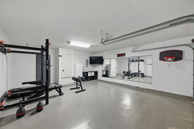 The garage features durable epoxy-painted floors, giving the space a clean, polished look that's easy to maintain. | Image 27