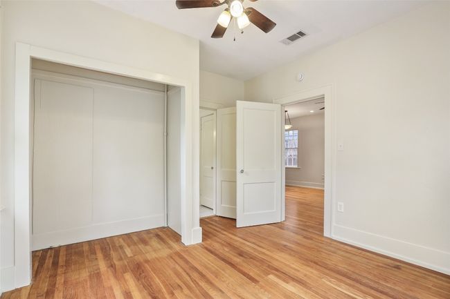 Unfurnished bedroom featuring light wood-type flooring, a closet, and a ceiling fan | Image 14