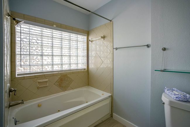 Bathroom with toilet and tub / shower combination | Image 13