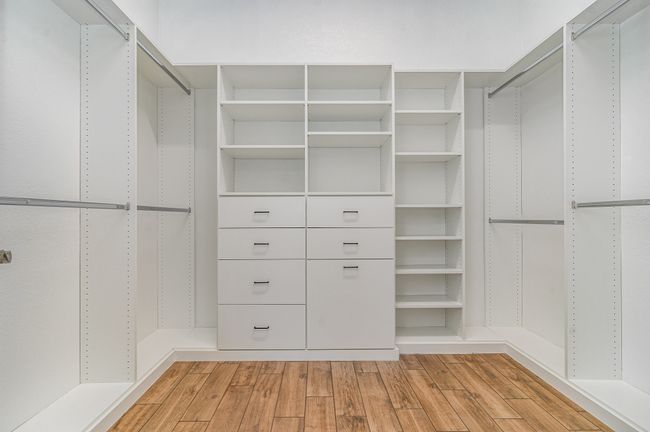 Spacious closet featuring light wood finished floors | Image 19