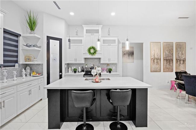 Kitchen with open shelves, a sink, light countertops, and recessed lighting | Image 18