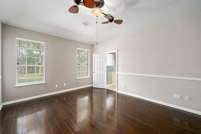 Primary suite on the first floor with great natural light, designer paint and wood floors | Image 20