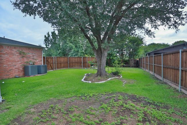 View of fenced backyard | Image 24