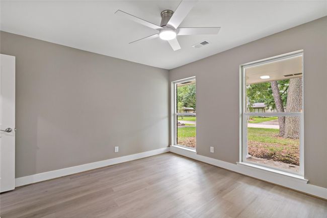 2nd bedroom view with large windows that provides natural lighting | Image 10