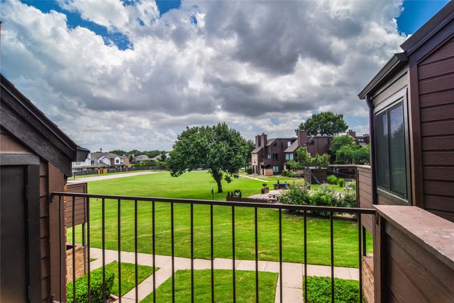 Balcony overlooking the greenbelt and the pool. | Image 8