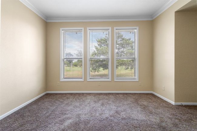 Primary bedrom with a wall of windows allowing for natural light. | Image 20