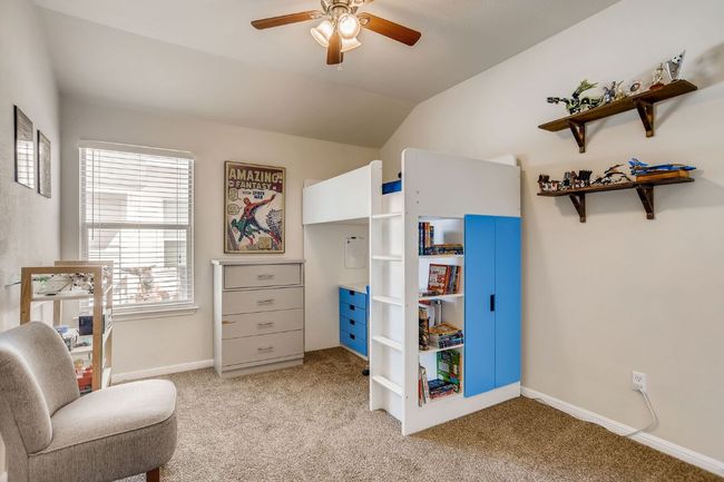 Living area with light colored carpet, a ceiling fan, and vaulted ceiling | Image 21