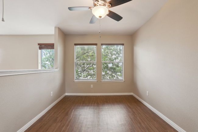 Spare room featuring wood finished floors, ceiling fan, and baseboards | Image 31