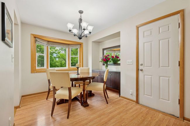 Dining area with cutout is perfect for a credenza. The bay window provides views of the wooded marshland. | Image 11