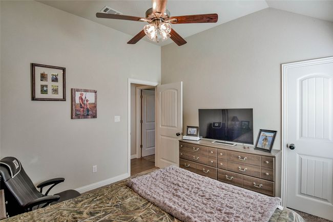 Bedroom with high vaulted ceiling, ceiling fan. | Image 27