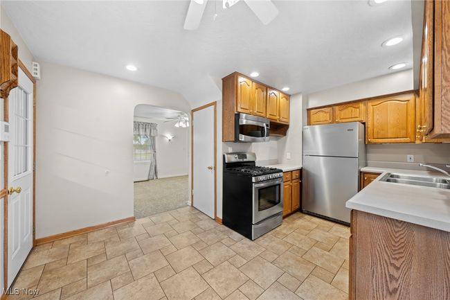 Kitchen with appliances with stainless steel finishes, sink, and ceiling fan | Image 10