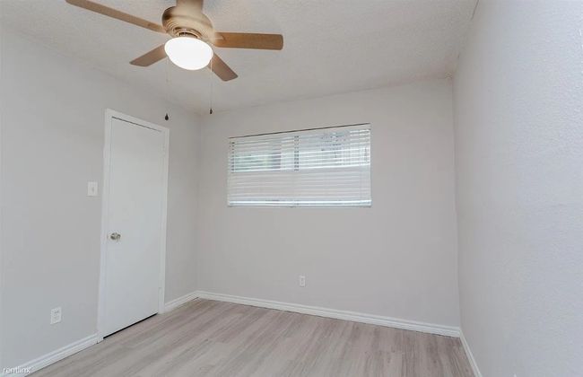 Empty room featuring light wood-style flooring and a ceiling fan | Image 7