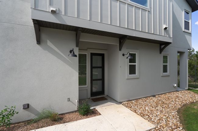 Doorway to property featuring stucco siding | Image 4