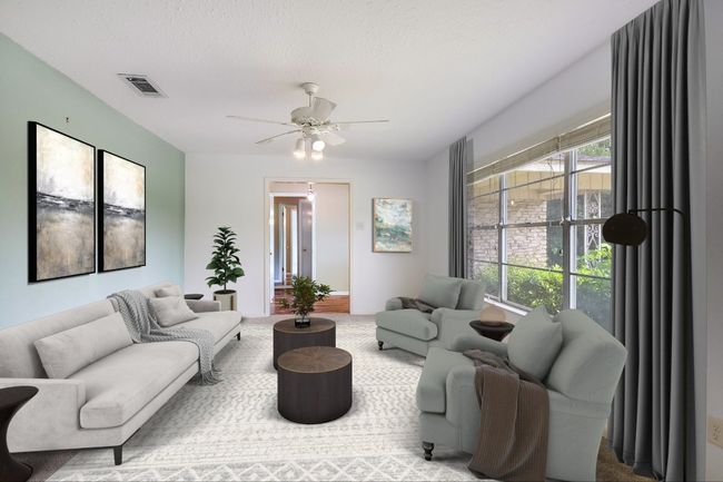 The front formal living area is large & can be used in a variety of ways. Enjoy the view of the trees! | Image 13