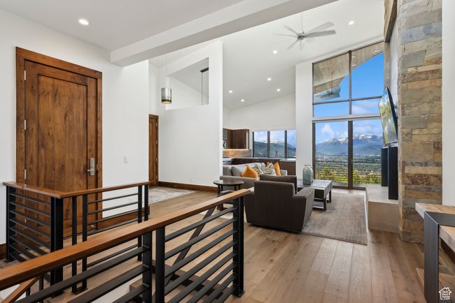 Living room featuring hardwood / wood-style flooring, high vaulted ceiling, ceiling fan, and recessed lighting | Image 87