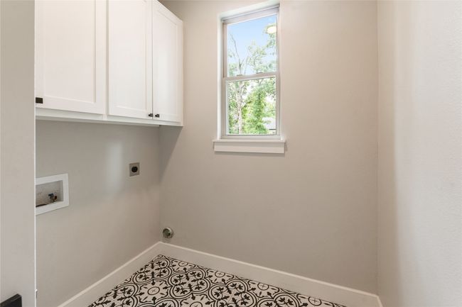 Custom cabinets, natural light, decorative tile floor | Image 12