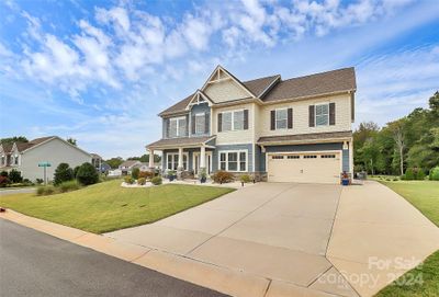 Homeowners extended the driveway with the extra parking space and a sidewalk leading to the rear of the home. | Image 2