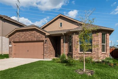 View of front of house featuring a garage and a front lawn | Image 1