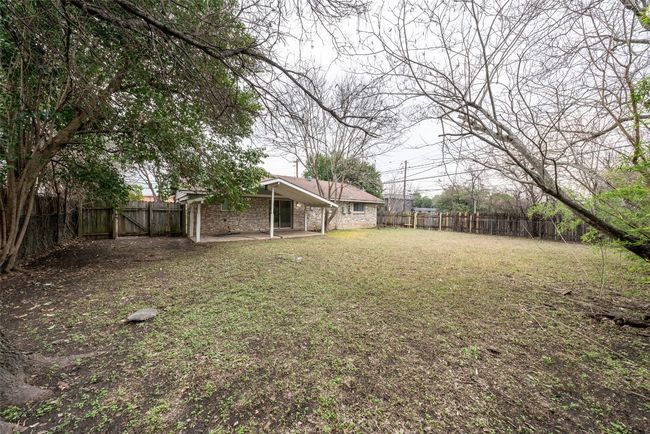 Fenced backyard with a patio area | Image 4