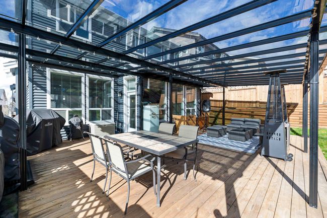 Deck with outdoor dining area, fence, and an outdoor hangout area | Image 16