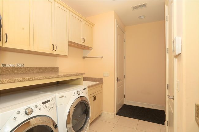 Front-loading washer and dryer make doing laundry less of a chore. The laundry sink is deep which is great for filling buckets. | Image 40