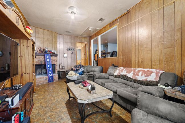 Living area with wood walls | Image 6
