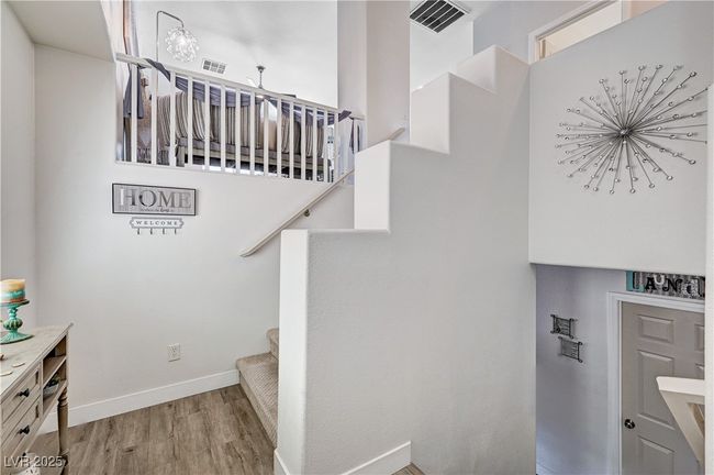 Staircase featuring wood finished floors and baseboards | Image 23