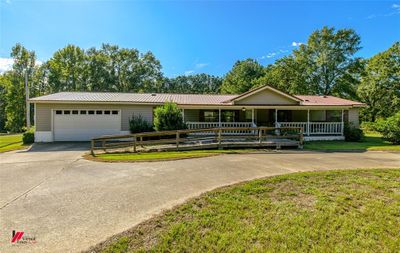 Ranch-style home featuring a garage and a front lawn | Image 3