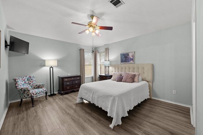 Bedroom with high ceilings, LVP floors, and ceiling fan | Image 12