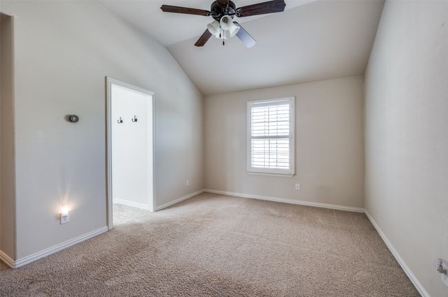Spare room featuring vaulted ceiling, light carpet, and ceiling fan | Image 30