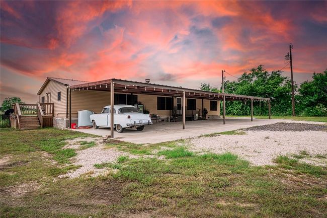 Front house at dusk featuring a yard | Image 5