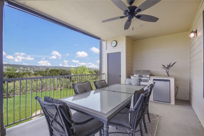View of patio / terrace with a ceiling fan, area for grilling, and amazing lake/hill country views | Image 9