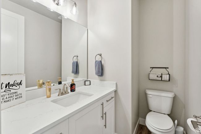 Half bathroom featuring toilet, vanity, and baseboards | Image 21