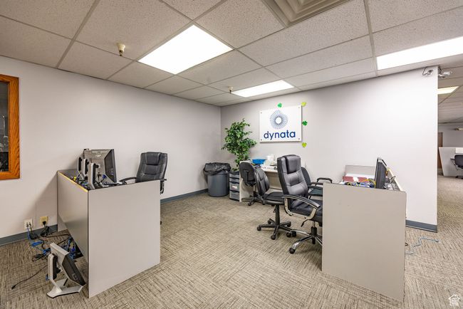 Carpeted office space featuring a drop ceiling | Image 5