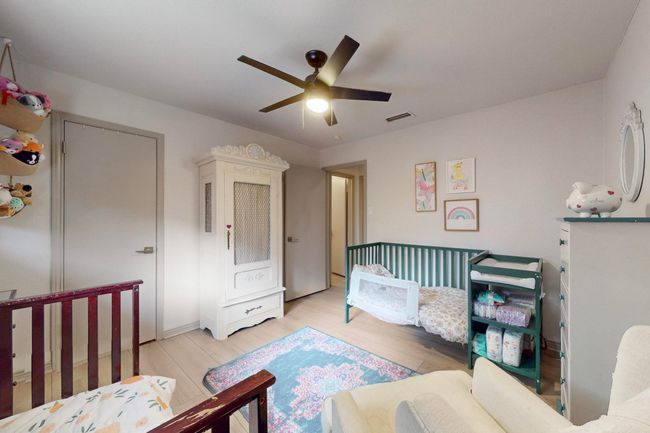 3rd Bedroom with light wood finished floors and ceiling fan | Image 27