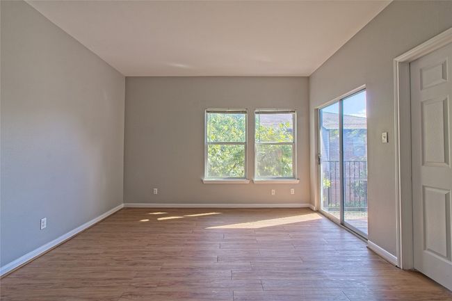 Empty room with baseboards and wood finished floors | Image 11