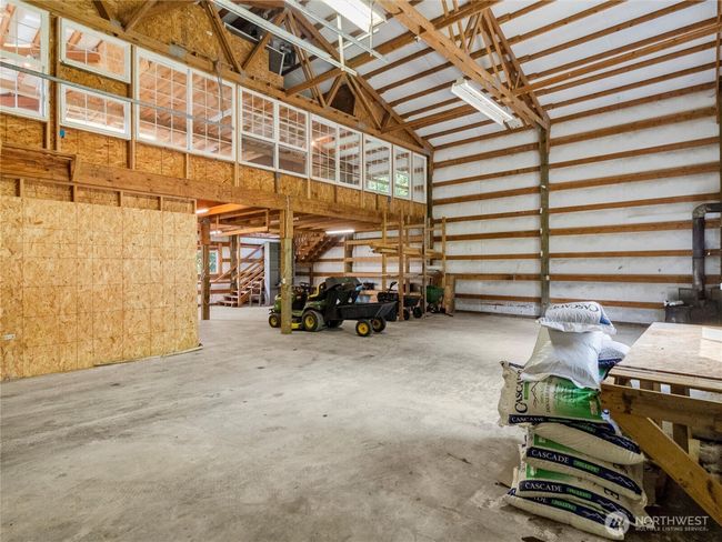 The bright shop fits RVs and includes a large rec room with ample windows. | Image 34