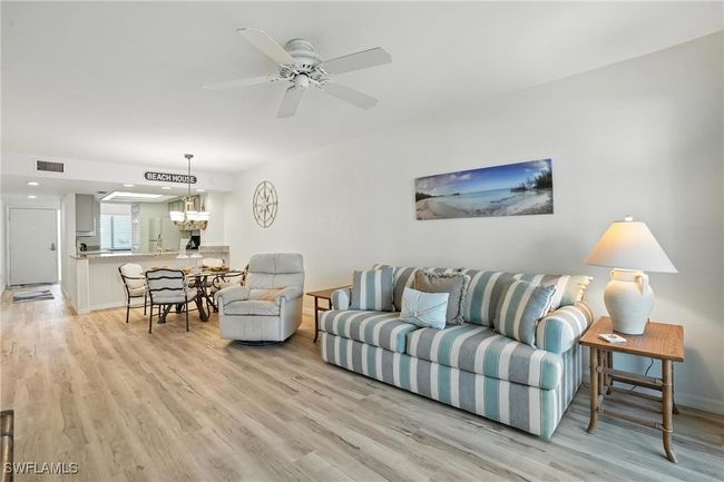 Living area featuring light wood-style floors and a ceiling fan | Image 8