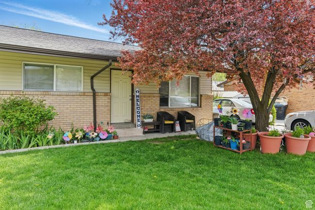 View of front facade with brick siding, a shingled roof, and a front yard | Image 16
