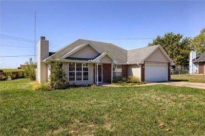 Ranch-style house featuring a front lawn and a garage | Image 2