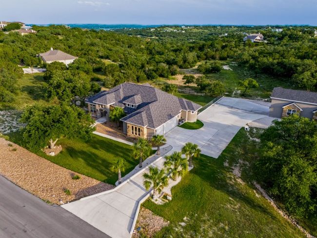 Aerial view of property and surrounding area featuring a heavily wooded area | Image 4