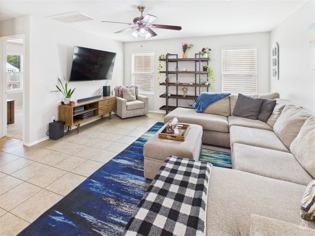 Living room featuring tile patterned flooring, plenty of natural light, and ceiling fan | Image 4