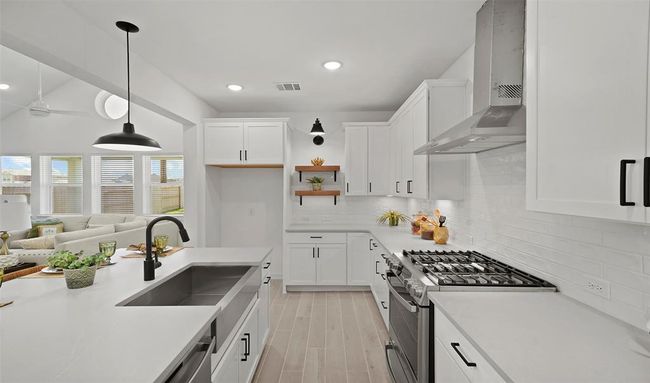 Beautiful island kitchen with white cabinets and quartz countertops (*Photo not of actual home and used for illustration purposes only.) | Image 12
