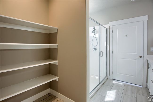 Bathroom with a shower stall and baseboards | Image 17