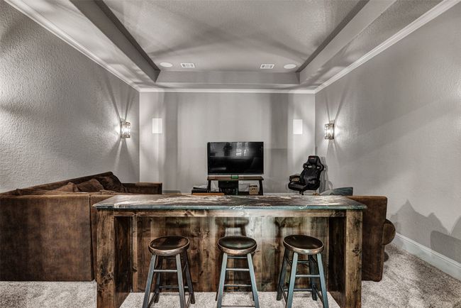 An elegant media room will help you take family movie nights or watching the big game to a new level! So handy to the large wet bar as well. | Image 14