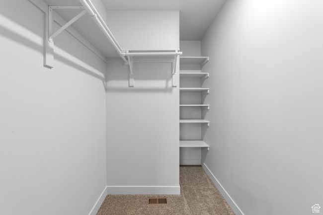 Spacious closet with carpet and visible vents | Image 34
